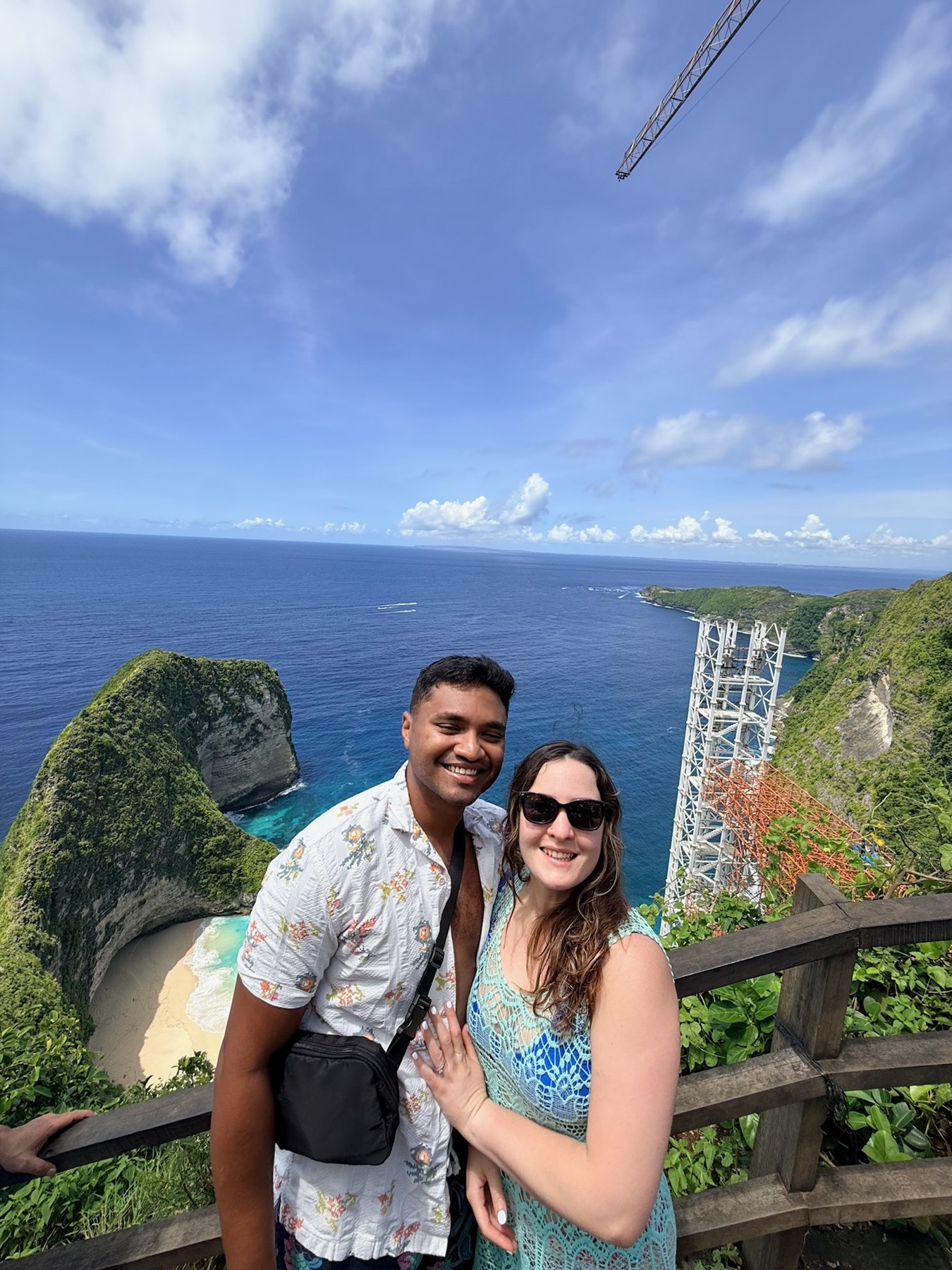 Giselle and Abhishek together above the turquoise sea in Bali